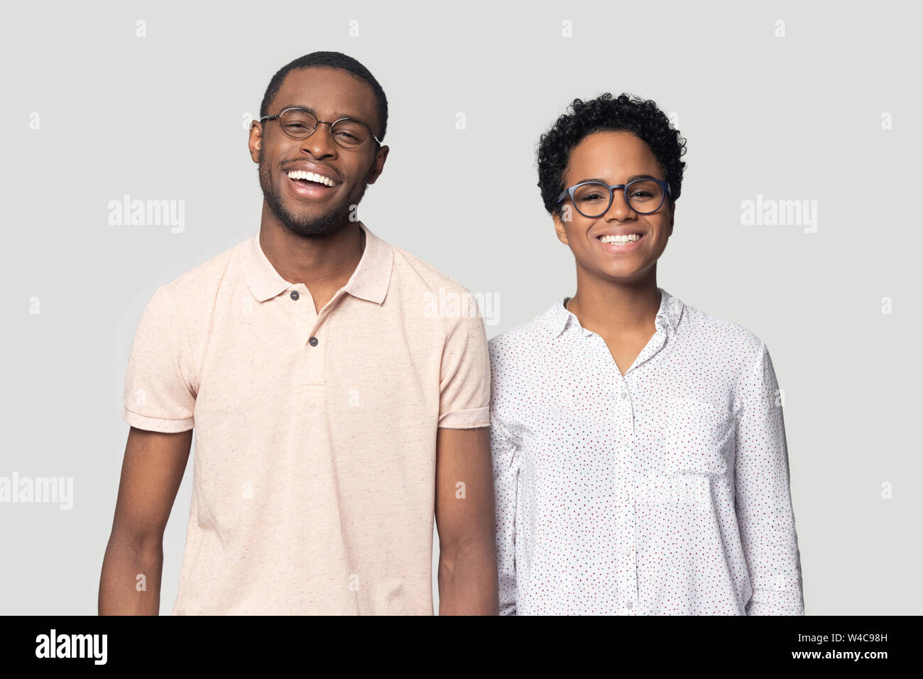 Smiling ethnic couple laugh posing for picture in studio Stock Photo