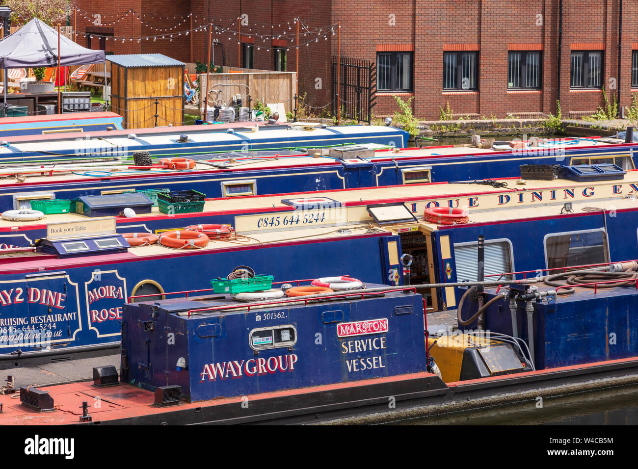 Colourful canal boats at the Gas Street Basin on the New Main Line Canal in the centre of Birmingham, UK Stock Photo