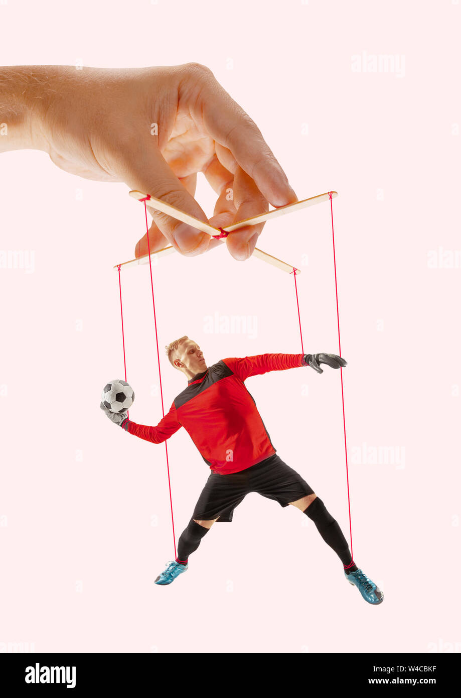 Hand Puppet Mocking Man like a puppet in somebodies hands on pink background. Concept of ...