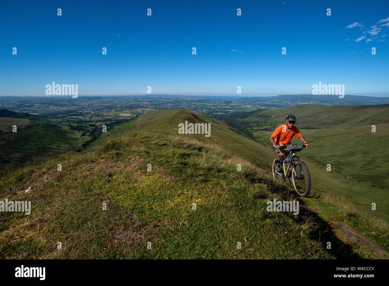 A man bike packing in the Brecon Beacons in Wales during the summer
