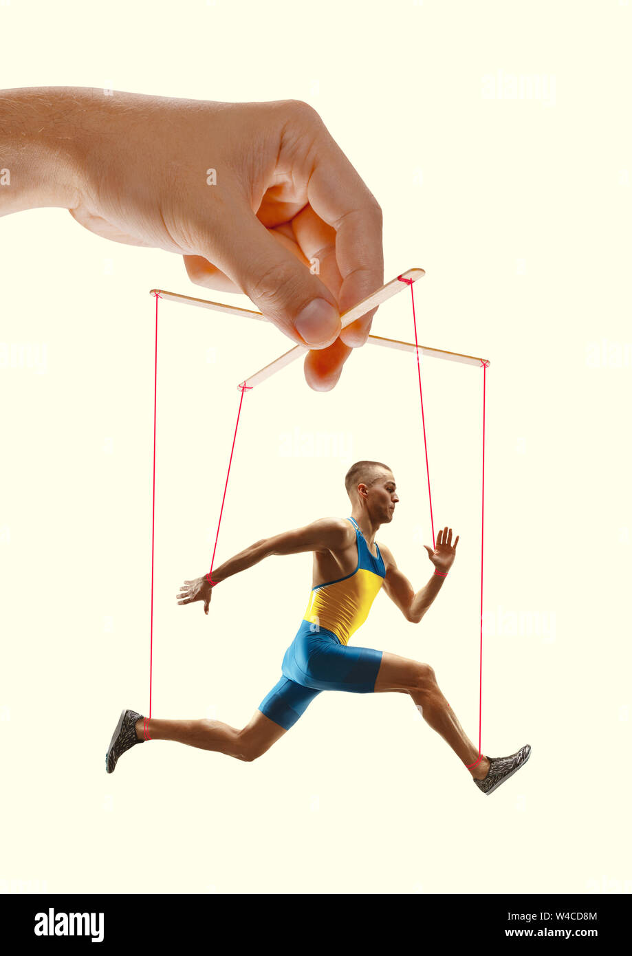 Hand Puppet Mocking Man like a puppet in somebodies hands on yellow background. Concept of ...