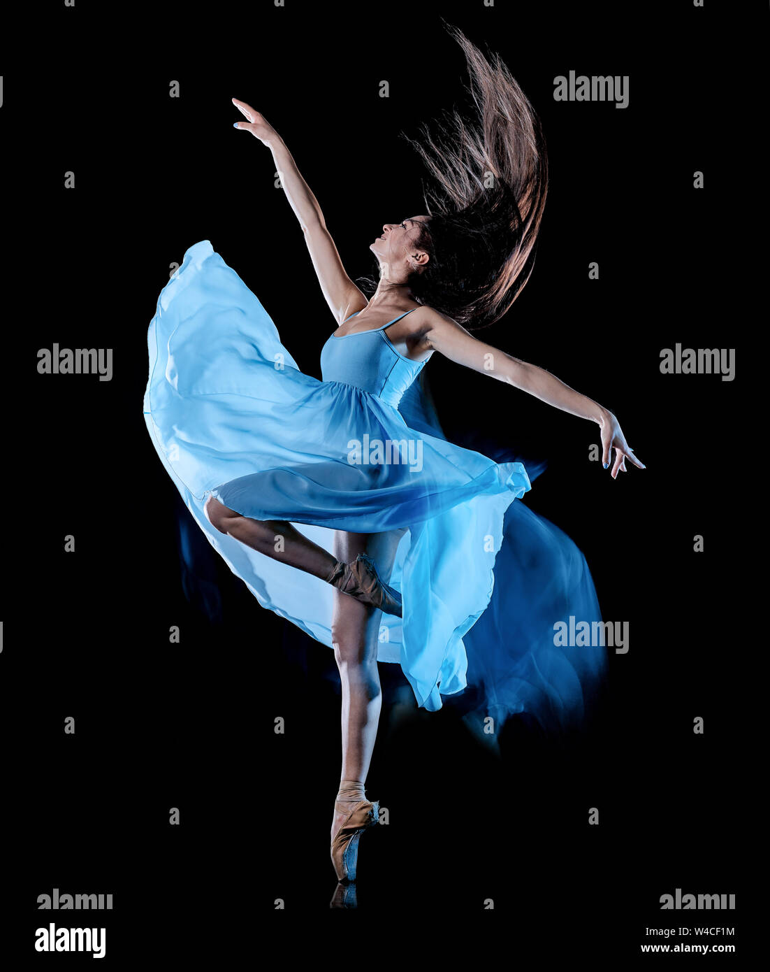 one caucasian young woman ballet dancer dancing isolated on black background with  light painting motion blur speed effect Stock Photo