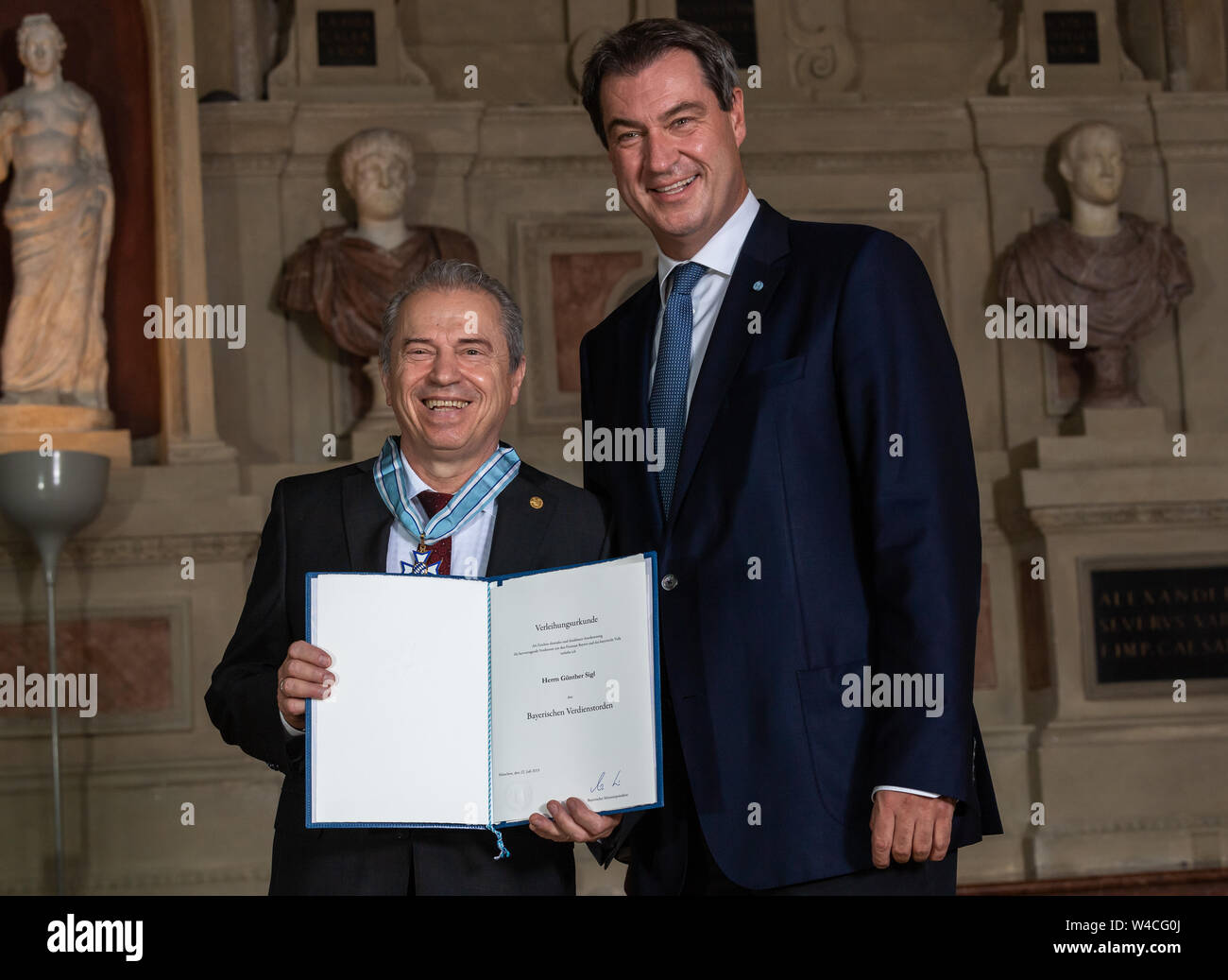 Munich, Germany. 22nd July, 2019. The musician Günther Sigl (l) from Gräfelfing receives the Bavarian Order of Merit from Markus Söder (CSU), Prime Minister of Bavaria. Credit: Peter Kneffel/dpa/Alamy Live News Stock Photo