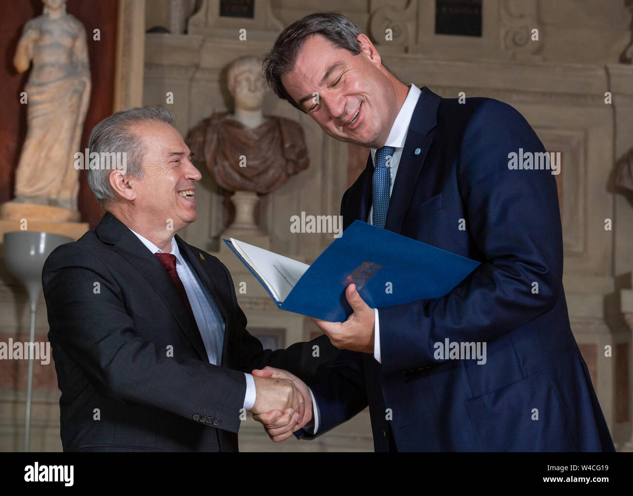Munich, Germany. 22nd July, 2019. The musician Günther Sigl (l) from Gräfelfing receives the Bavarian Order of Merit from Markus Söder (CSU), Prime Minister of Bavaria. Credit: Peter Kneffel/dpa/Alamy Live News Stock Photo