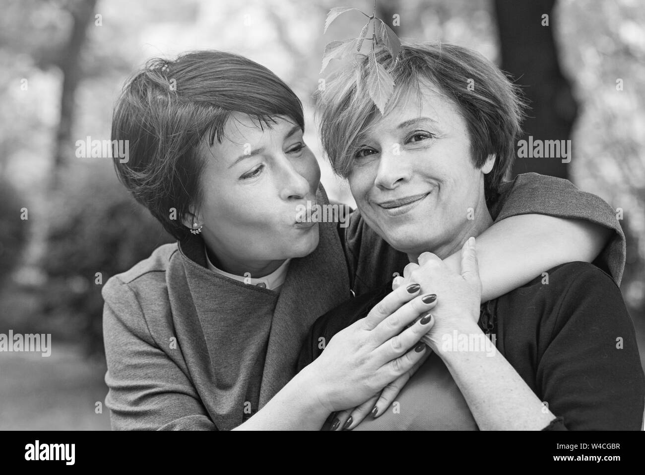 Happy older mother and mature daughter outdoor, black and white portrait Stock Photo