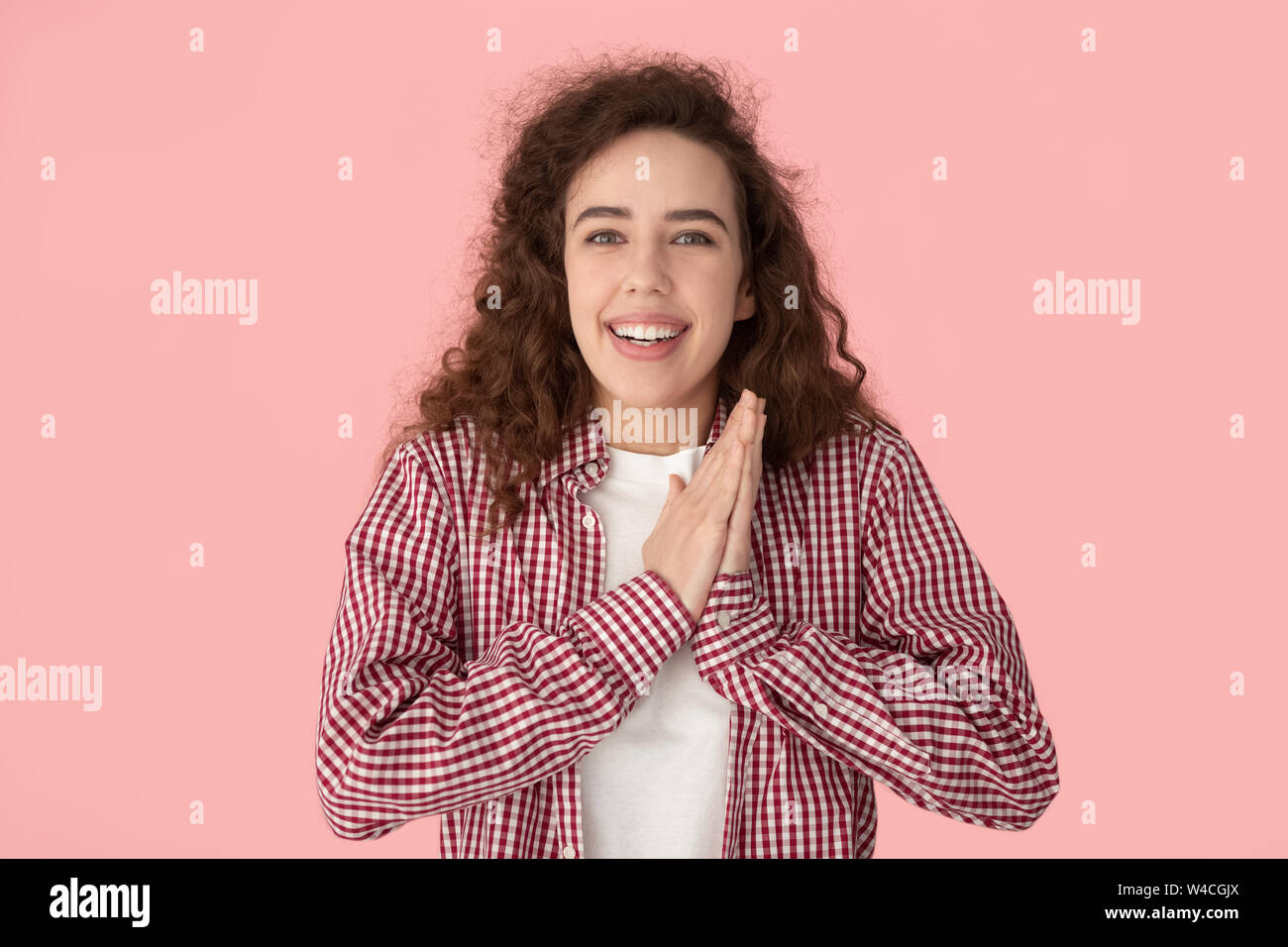 Girl folded palms together enjoy moment of success got desired Stock Photo