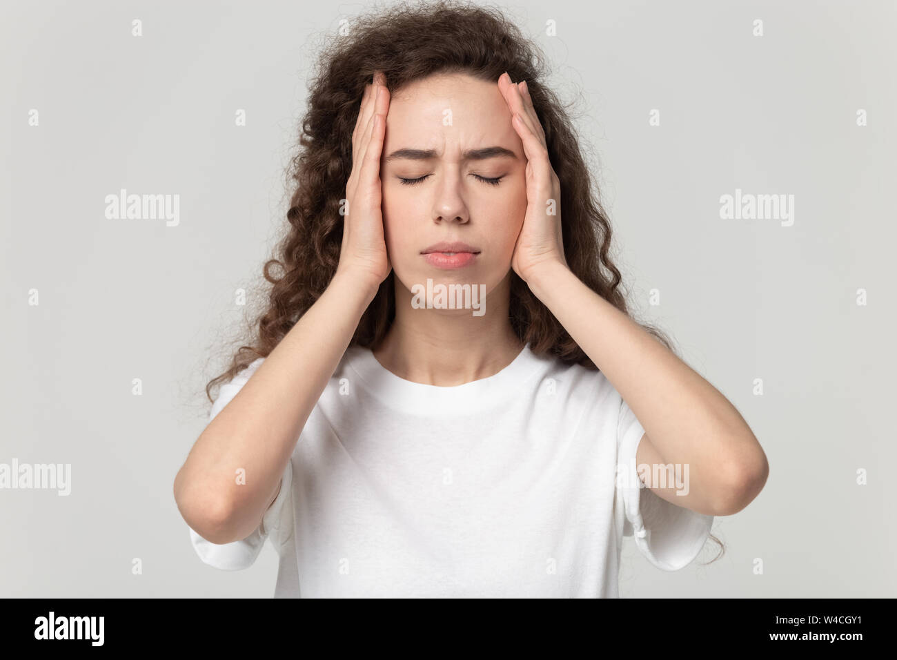 Head shot portrait stressed woman touching temples suffers from