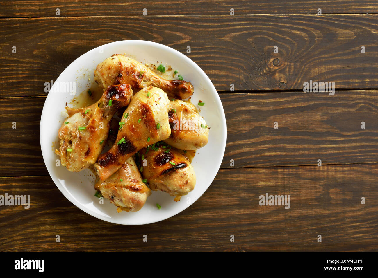 Chicken drumstick on white plate, top view Stock Photo