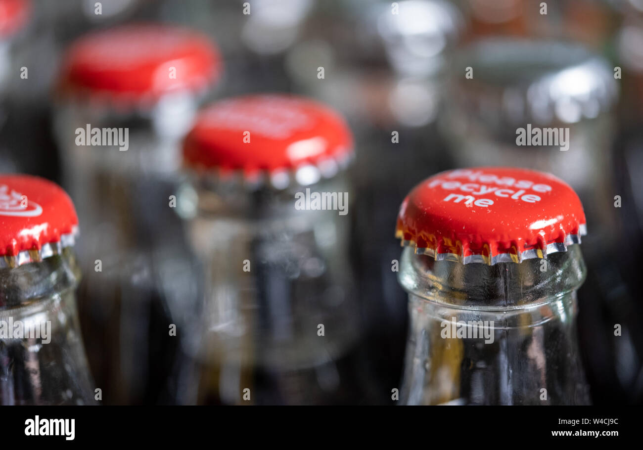 Red metals caps on the top of retro style glass coca cola bottles