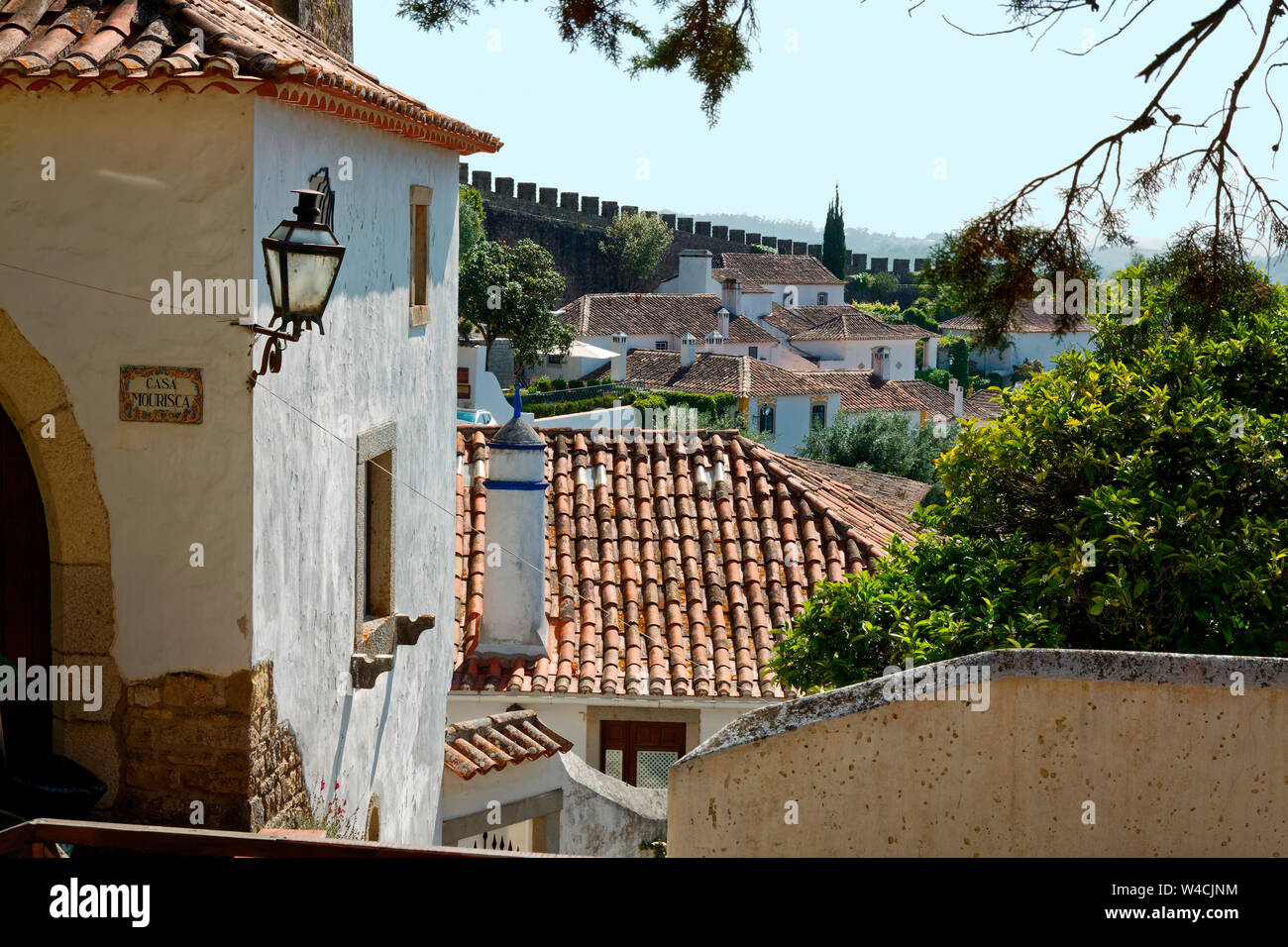 hillside houses, old stone city wall, tile roofs, Europe, Obidos