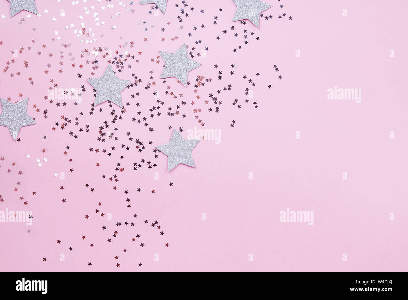 Star shaped confetti on pastel pink background, festive backdrop Stock ...