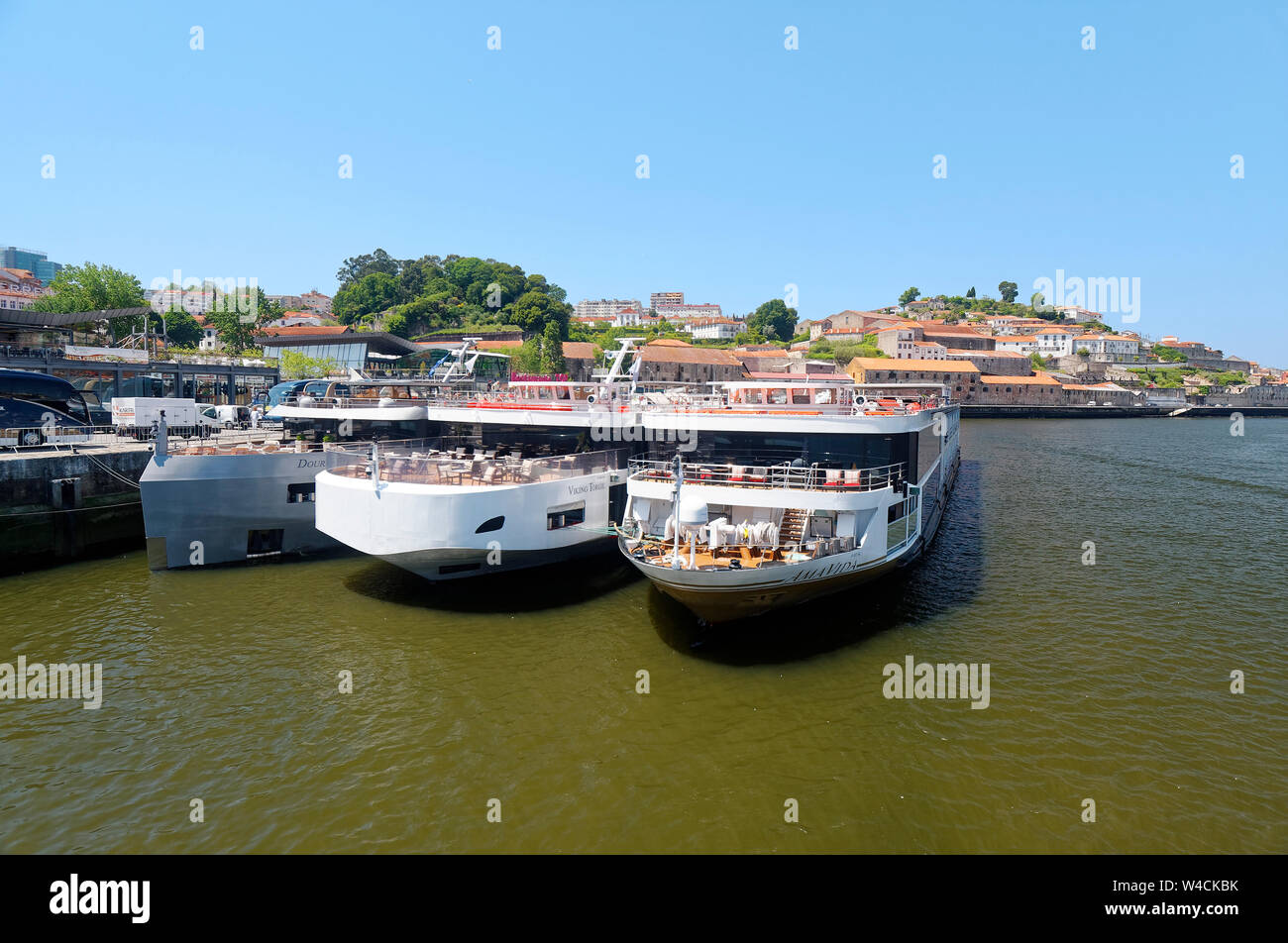 3 riverboats docked together, city, buildings, Douro River, water, scene, Europe, Porto, Portugal, spring, horizontal Stock Photo