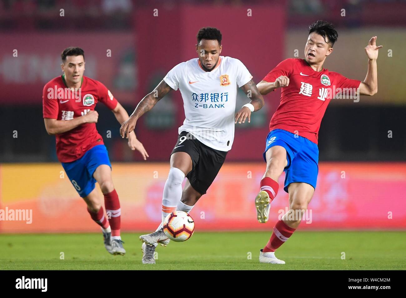 Brazilian football player Rafael Pereira da Silva, commonly known as Rafael or Rafael da Silva, middle, of Wuhan Zall F.C. keeps the ball during the 19th round of Chinese Football Association Super League (CSL) against Henan Jianye in Zhengzhou, central China’s Henan province on 21 July 2019. The match ened with a draw 0-0. Stock Photo
