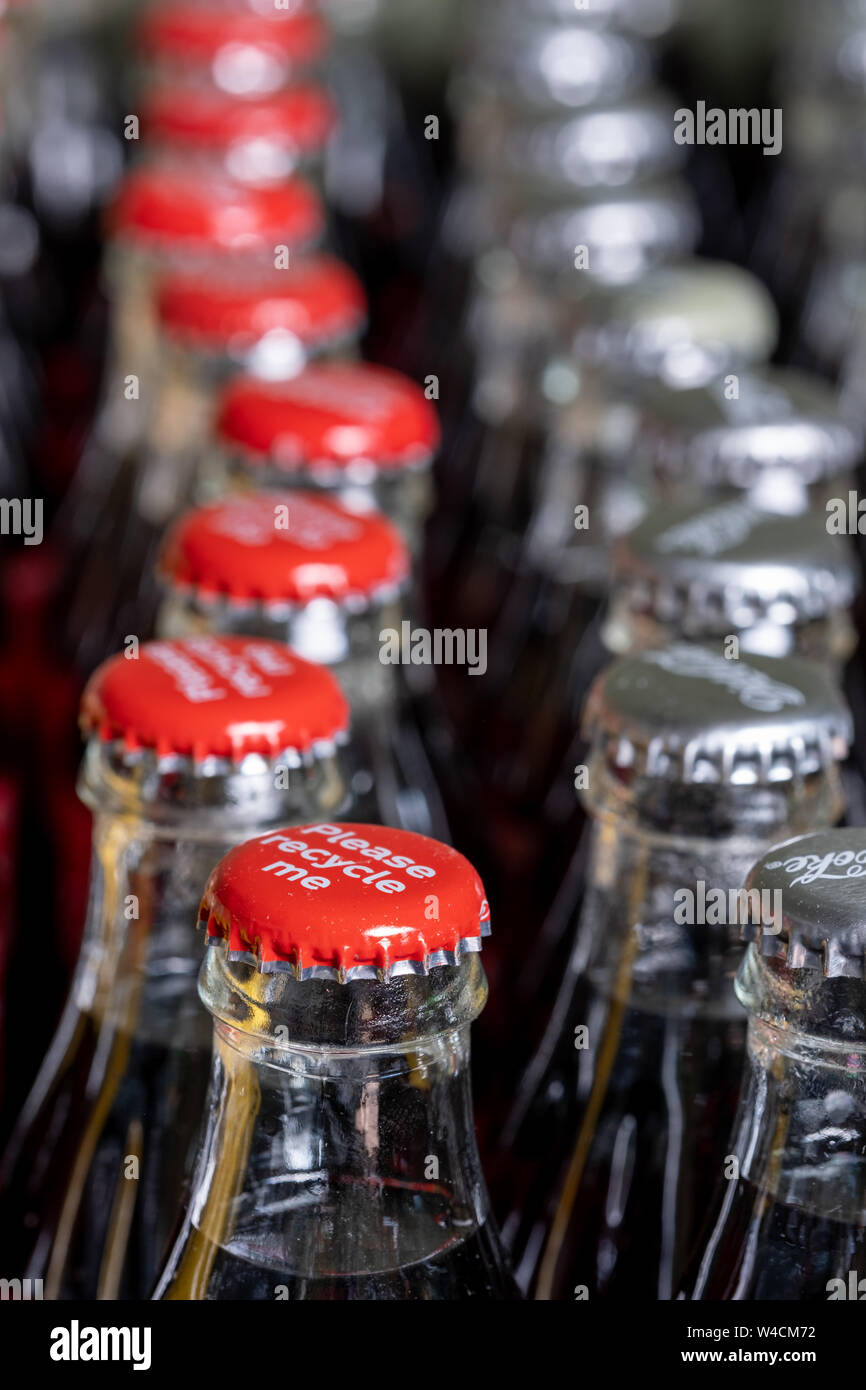 Red metals caps on the top of retro style glass coca cola bottles