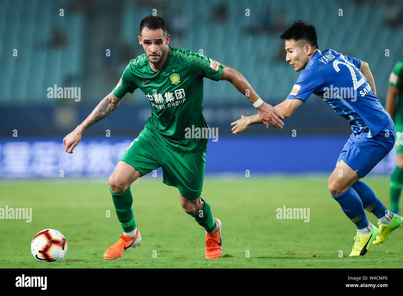 Brazilian football player Renato Soares de Oliveira Augusto, or simply Renato Augusto, left, of Beijing Sinobo Guoan F.C. keeps the ball during the 19th round of Chinese Football Association Super League (CSL) against Jiangsu Suning in Nanjing, east China’s Jiangsu province on 21 July 2019. Jiangsu Suning wins in the match with a 1-0. Stock Photo