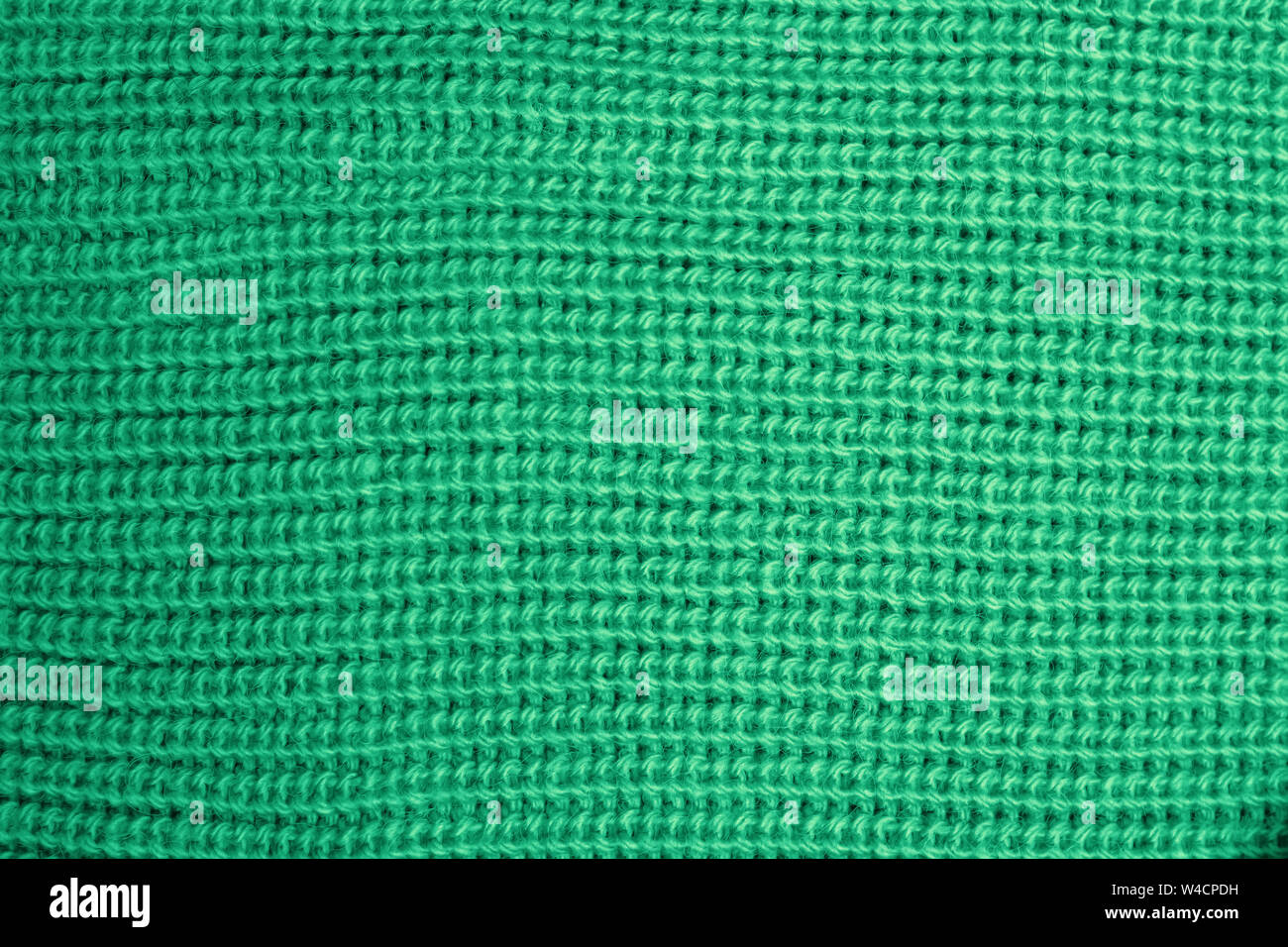 Woolen knitted texture of pastel green or mint color close-up Stock Photo