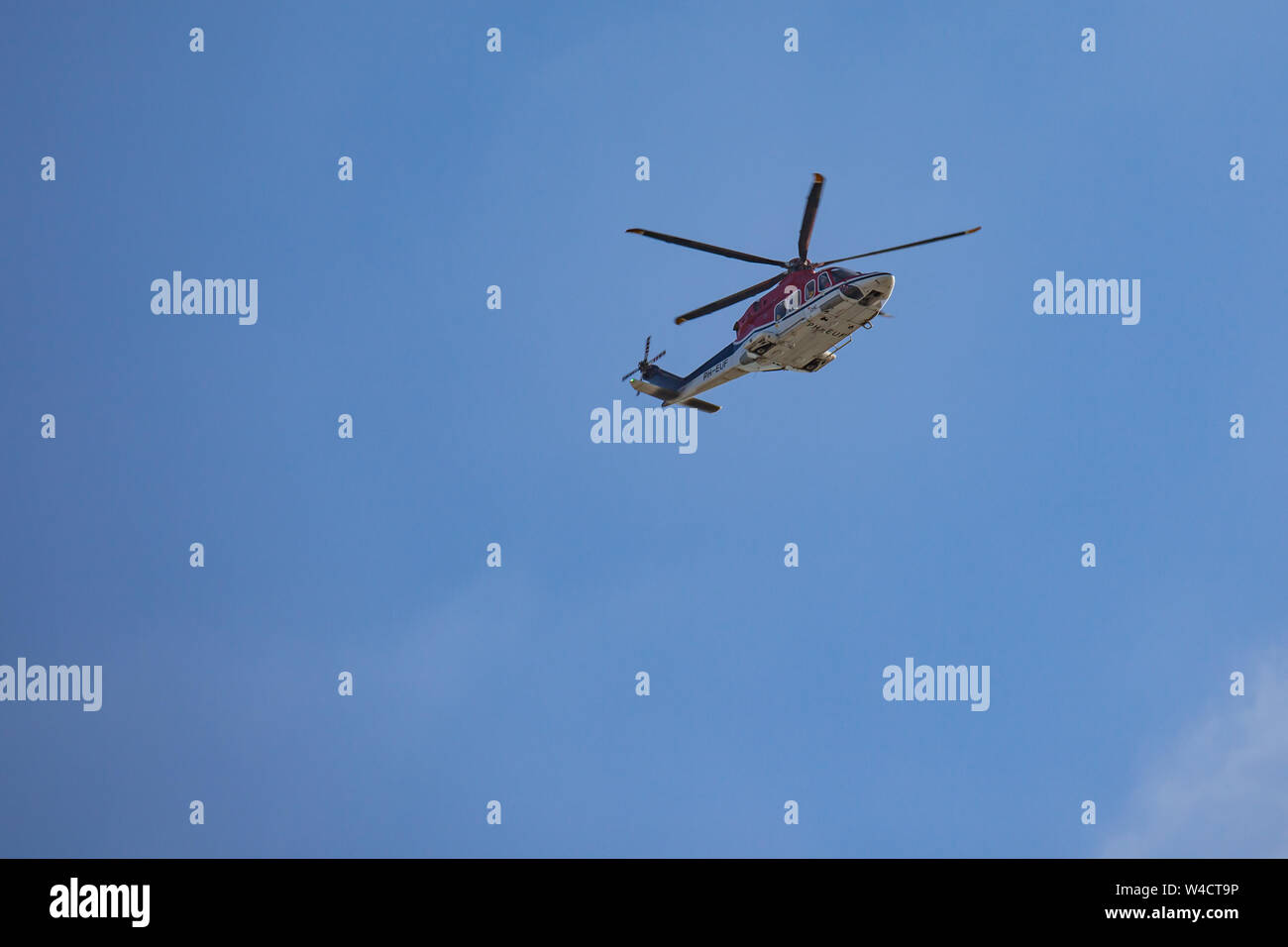 Egmond aan Zee, Netherlands - July 22,2019: an Agusta Westland helicopter on a shuttle flight from an offshore drilling platform to Den Helder Stock Photo