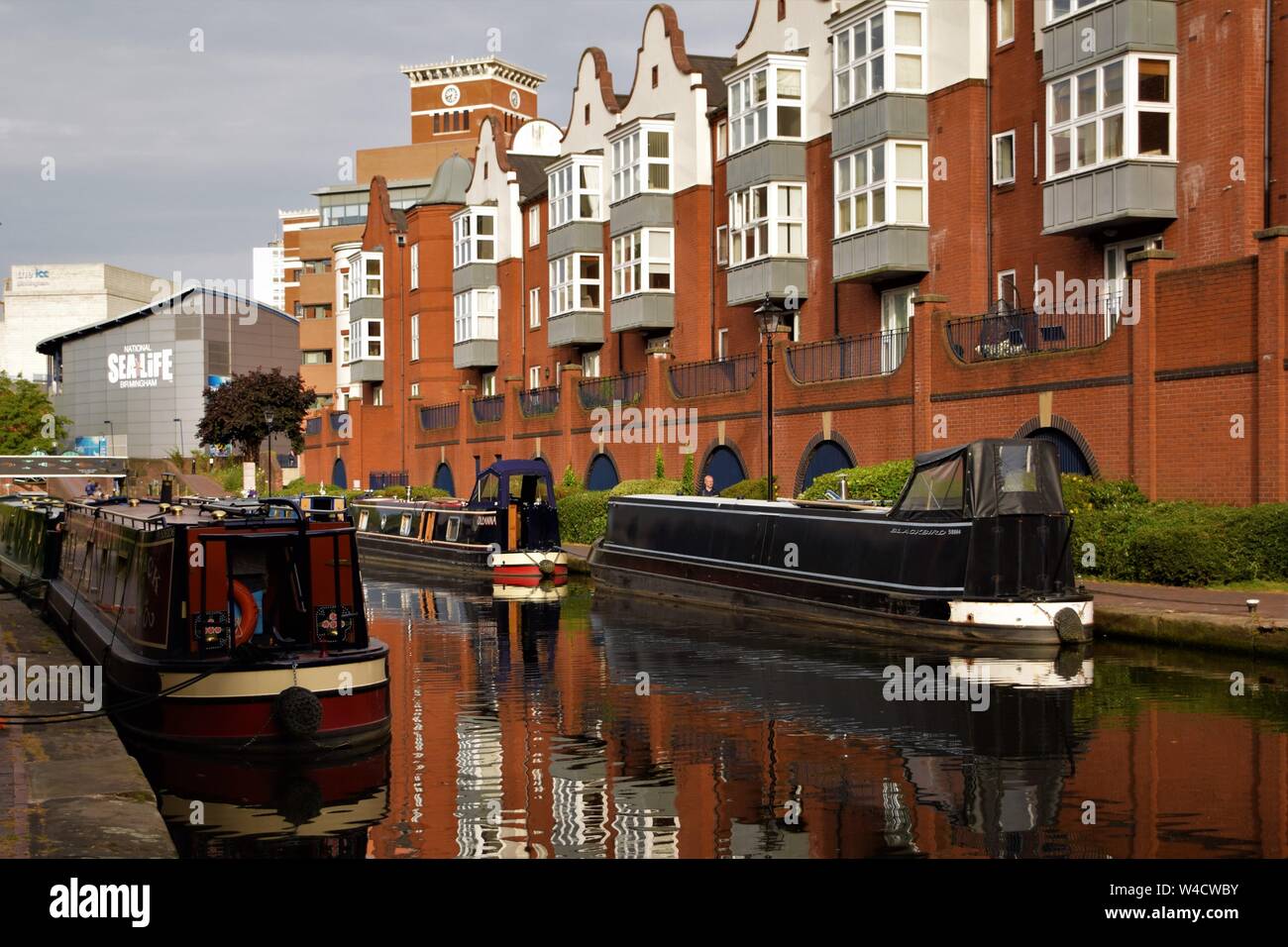 Birmingham England canal views moored narrow boats, bridges over the water, traditional British houses Stock Photo