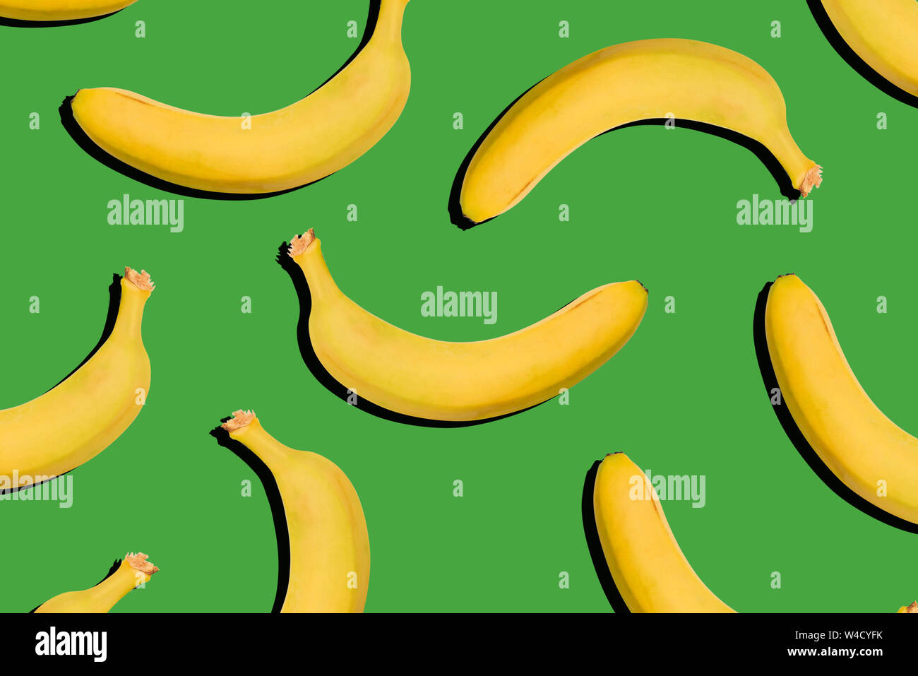 Bananas on a green background. Healthy food, nutrition concept. Creative style, modern art Stock Photo
