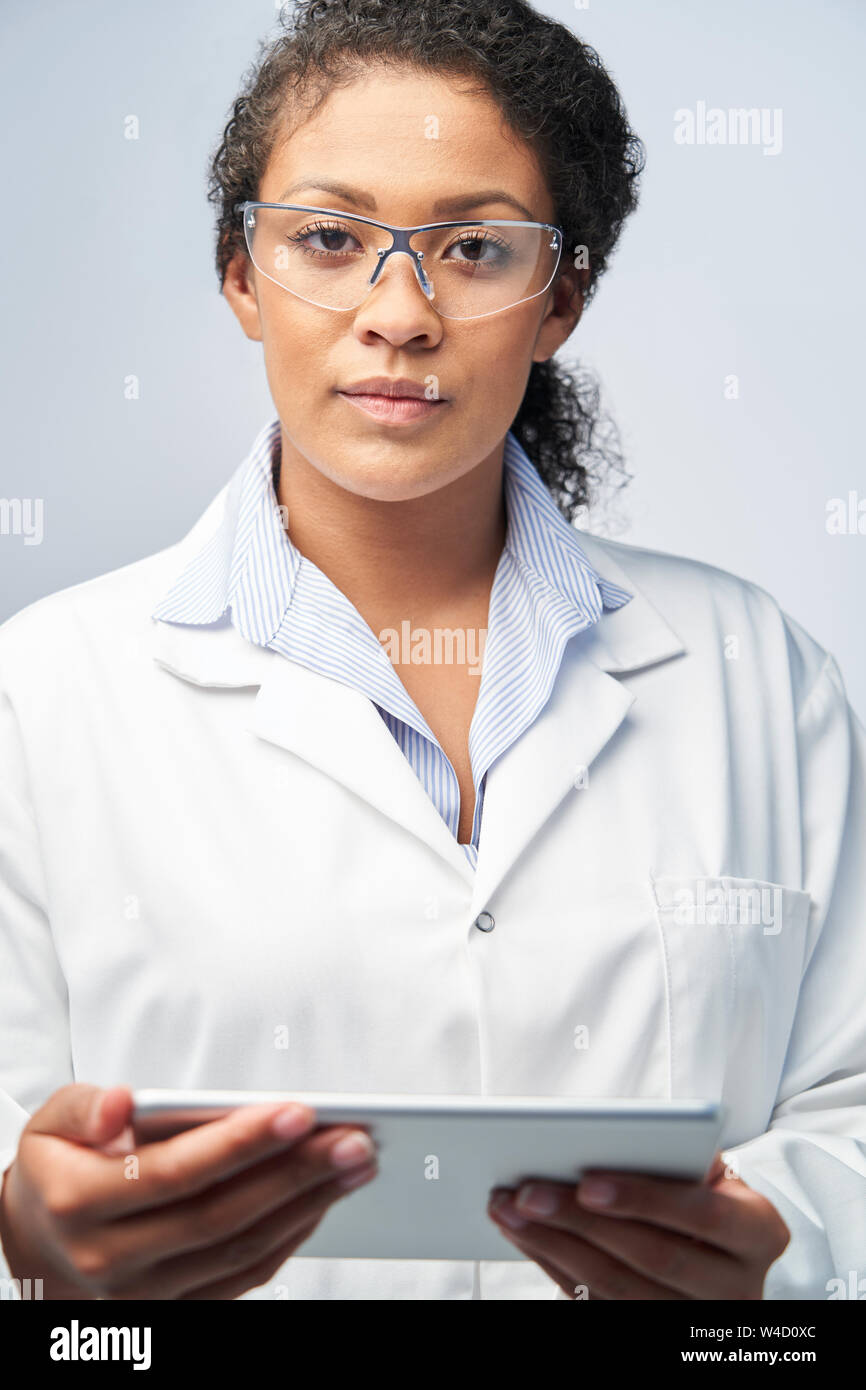 Studio Portrait Of Female Laboratory Technician Working With Digital Tablet Stock Photo