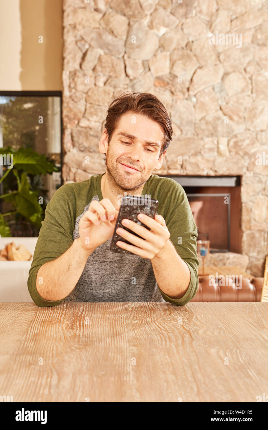 Young man using smartphone while chatting or writing a text message Stock Photo