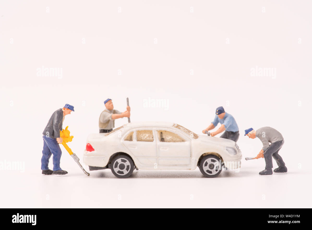 Miniature mechanics repairing toy car,concept of the Stock