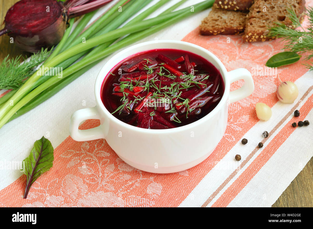 Borscht with dill in white bowl. Beetroot soup Stock Photo