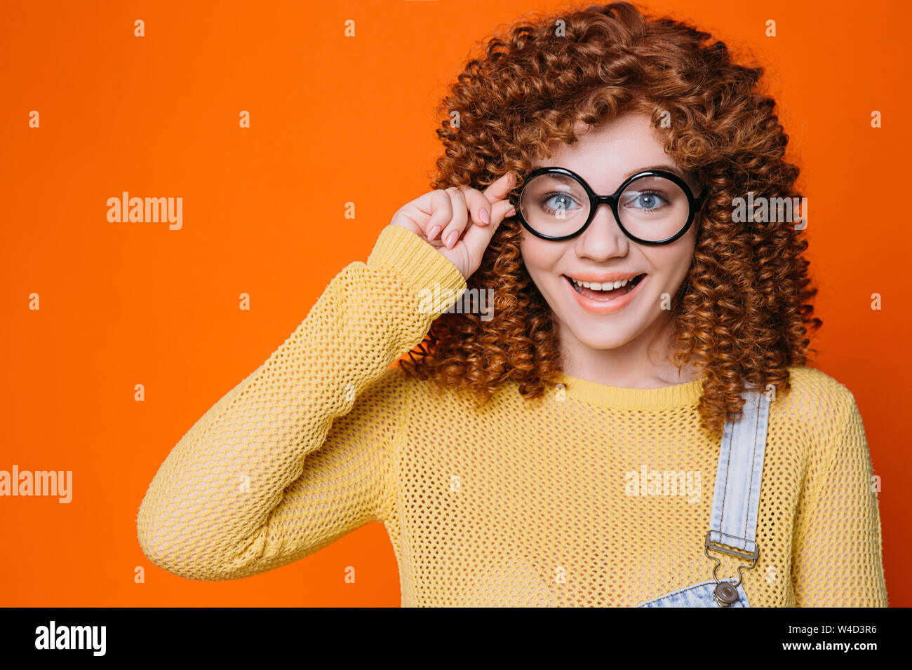 Smiling happy Student woman adjusting her eyeglasses Stock Photo