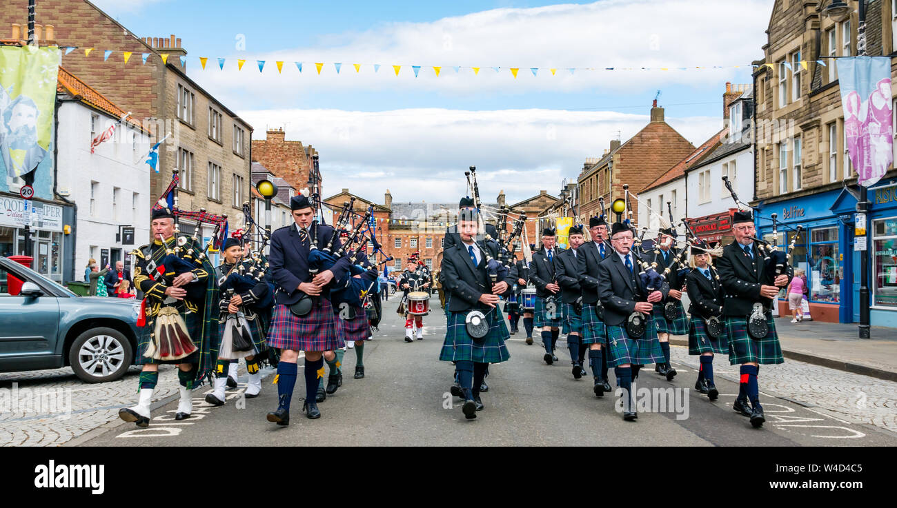 Traditional Scottish pipe band parades down High Street, Dunbar, East Lothian, Scotland, UK Stock Photo