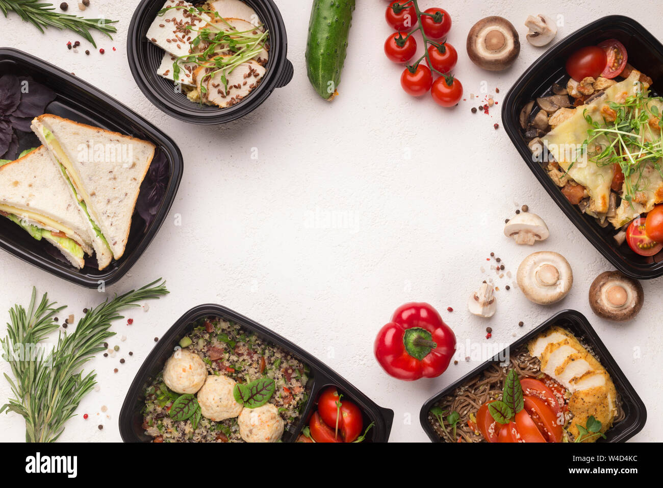 Healthy food delivery in black boxes with tasty meal on white Stock