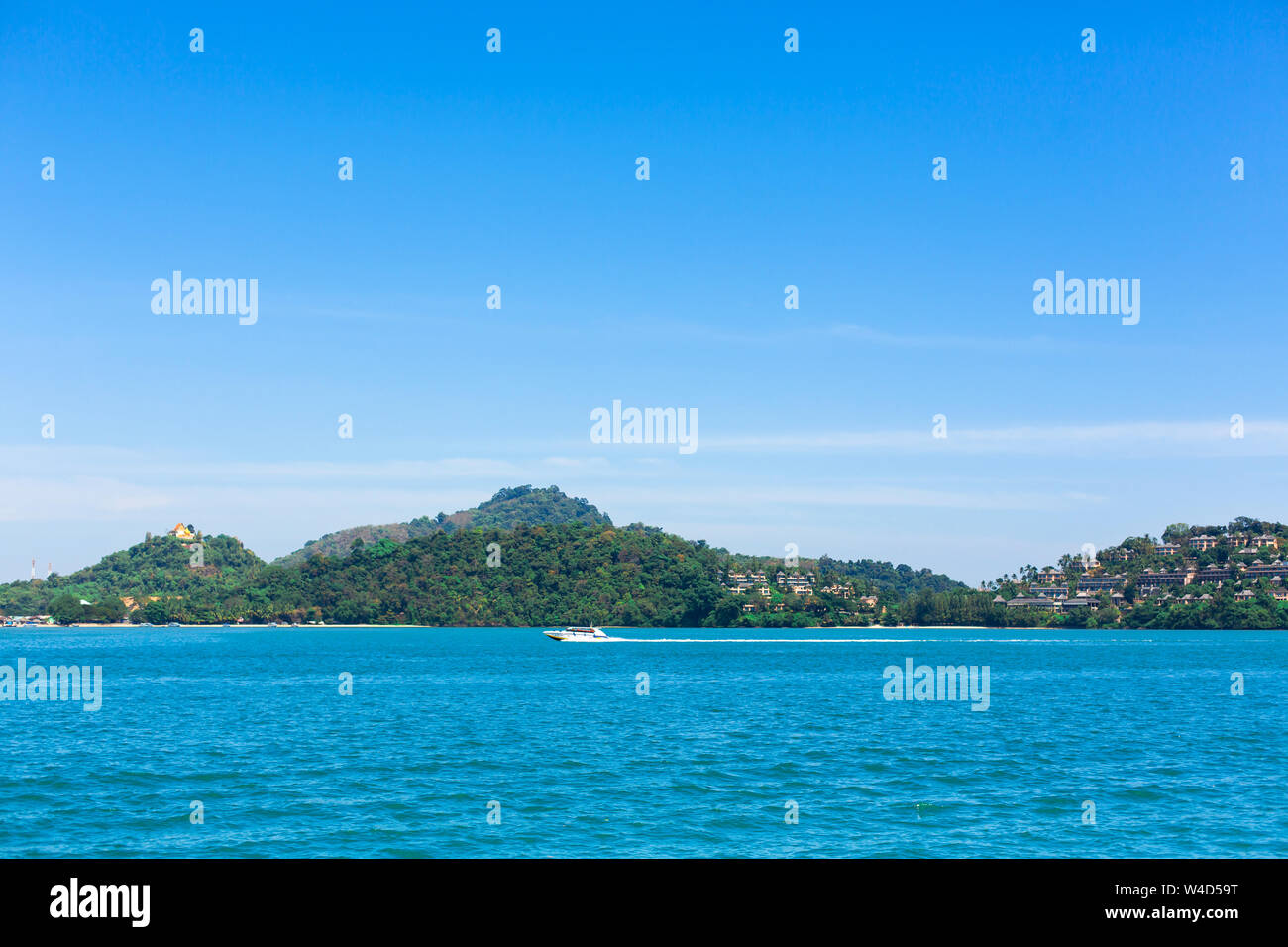 View of a green island in the blue ocean Stock Photo - Alamy