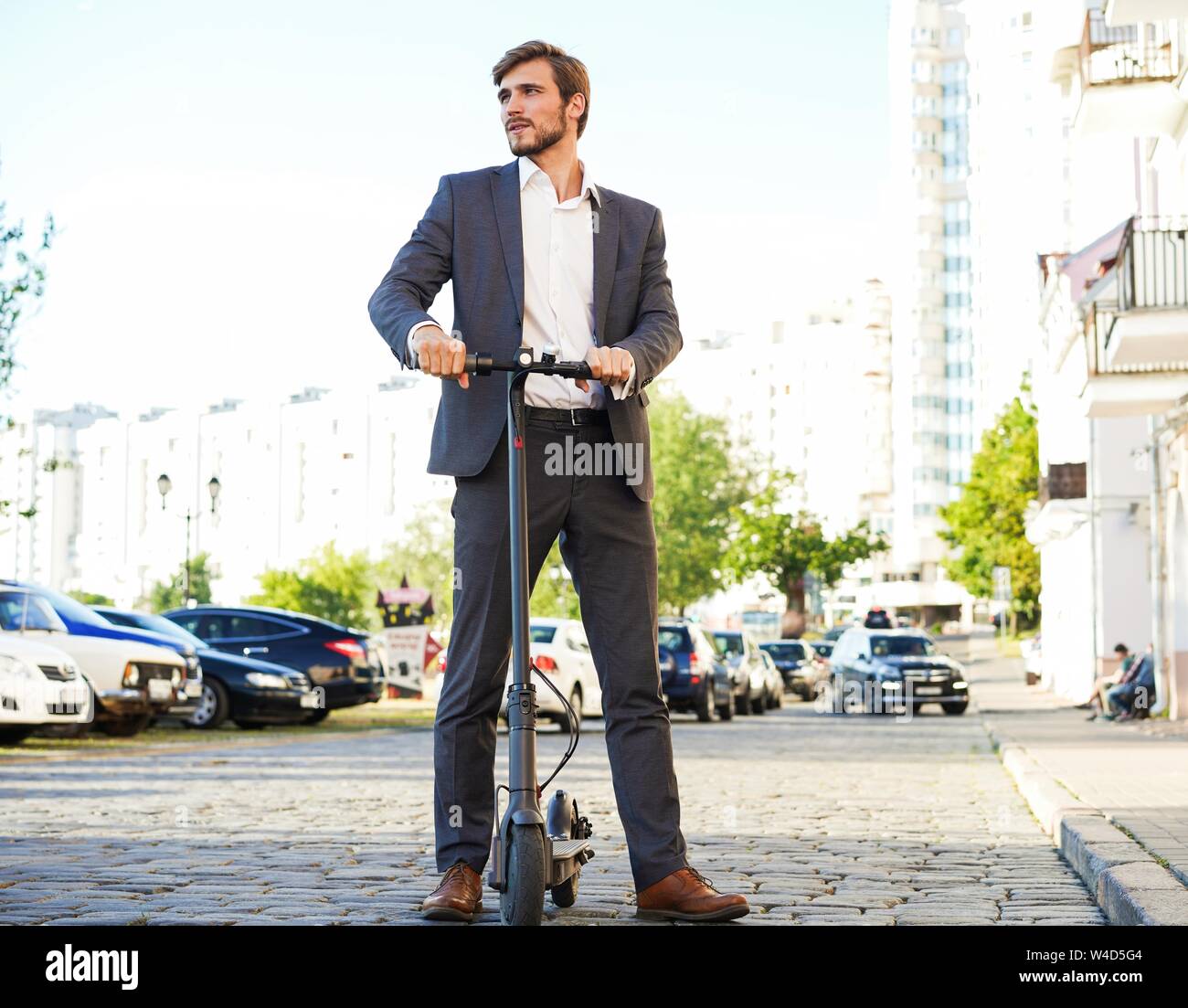 Man in suit on electric scooter hi-res stock photography and images - Alamy