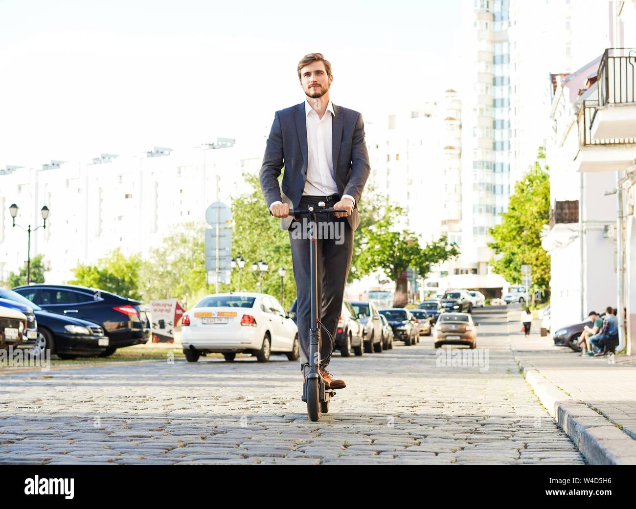 Man in suit on electric scooter hi-res stock photography and images - Alamy