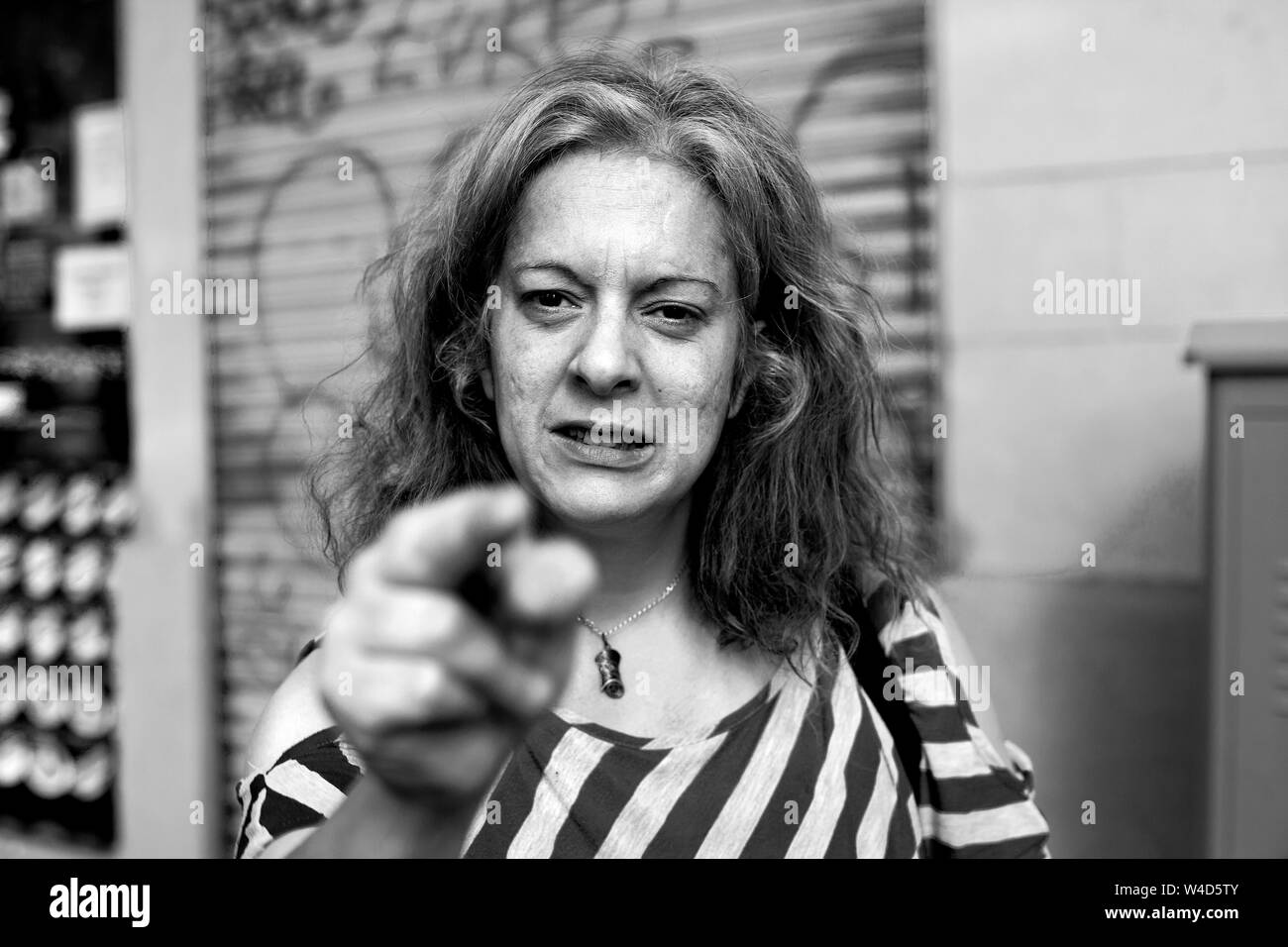 Angry alcoholic woman in the street, Barcelona, Spain. Stock Photo