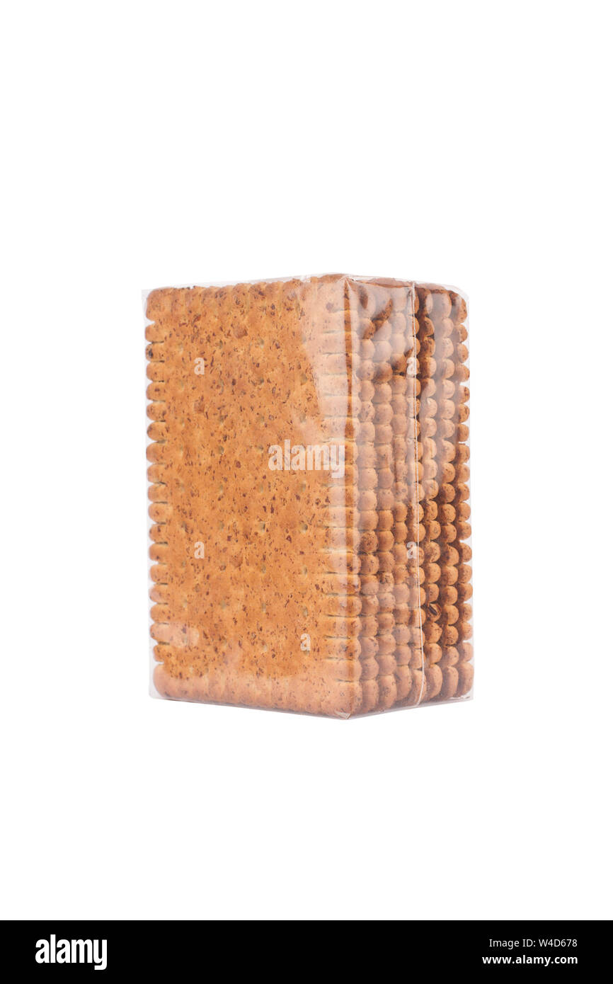 side view closeup of square shaped whole grain pack of brown biscuit in transparent plastic packaging isolated on white Stock Photo