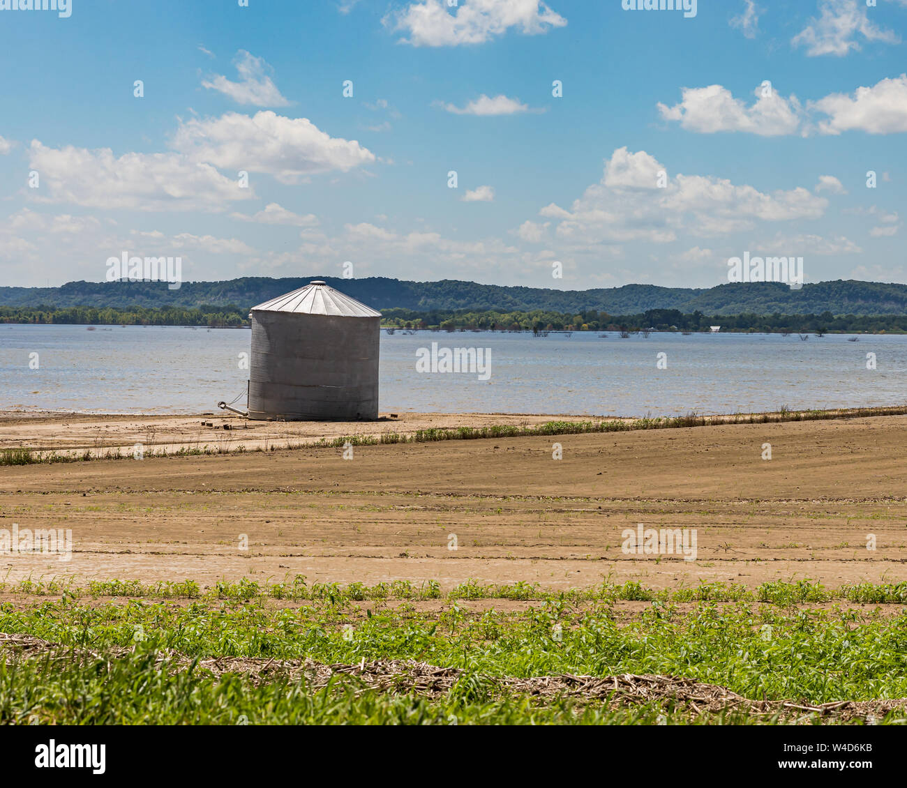 Mississippi River flooding has damaged farm building and grain bins, which is revealed as flood waters are receding Stock Photo