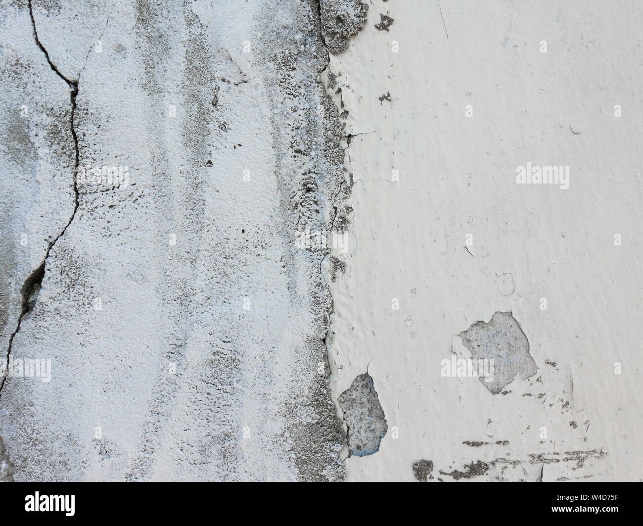 Old grungy, weathered concrete wall and cracked white paint peeling off the beton structure. Abstract construction element surface, dirty texture with Stock Photo