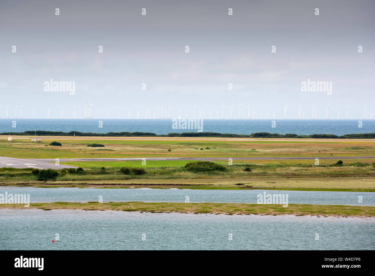 Looking across the Walney channel to Walney Island with the Walney offshore wind farm beyond, Cumbria, UK. Stock Photo