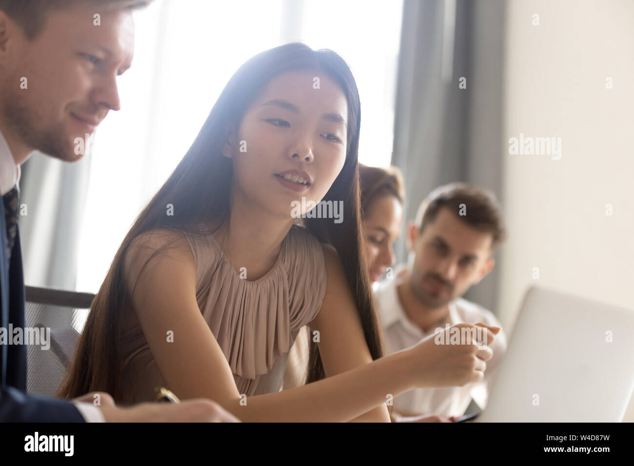 Focused asian businesswoman professional looking at laptop during office meeting Stock Photo