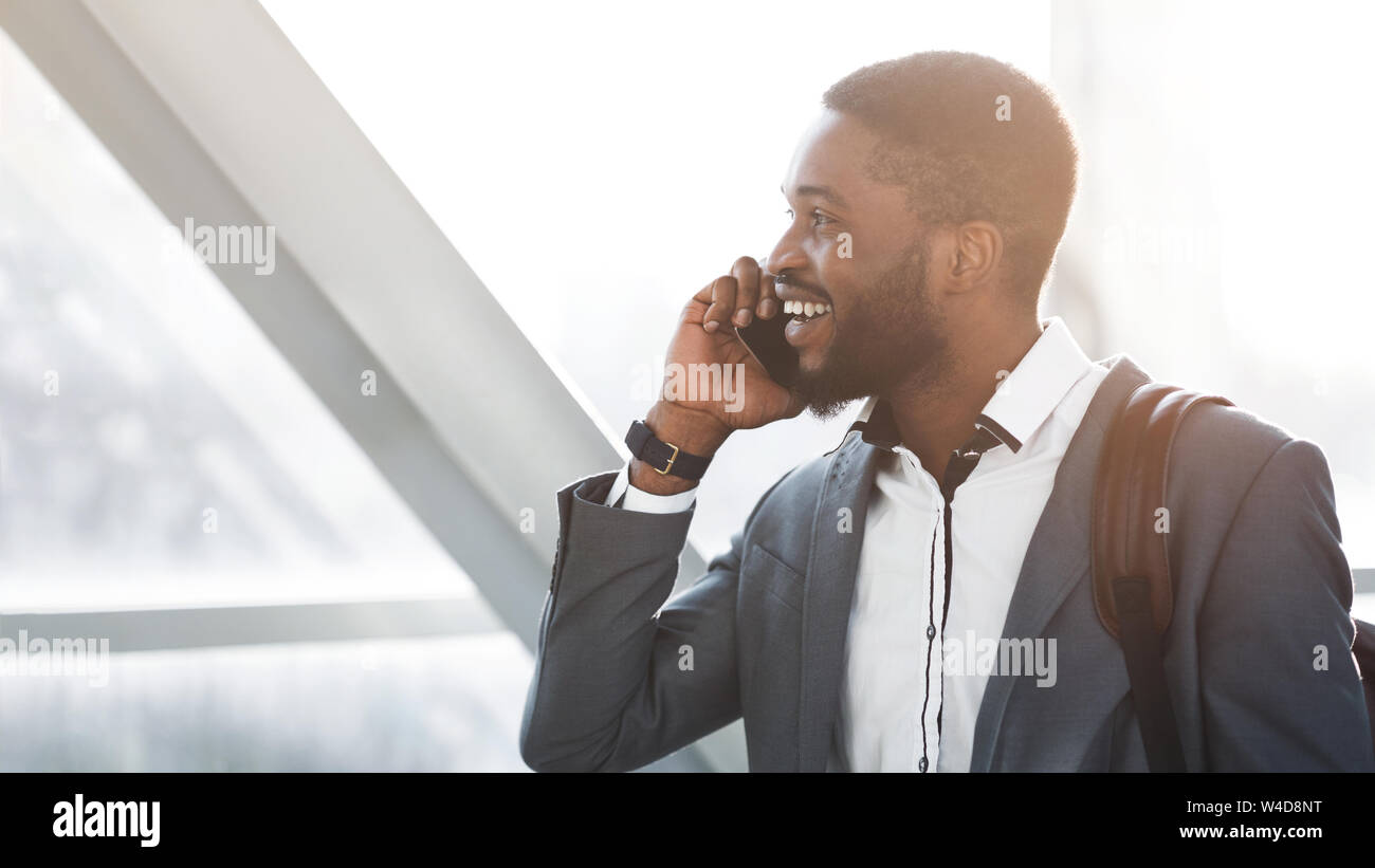 Always in Touch. Afro Businessman Having Phone Talk in Airport Stock Photo