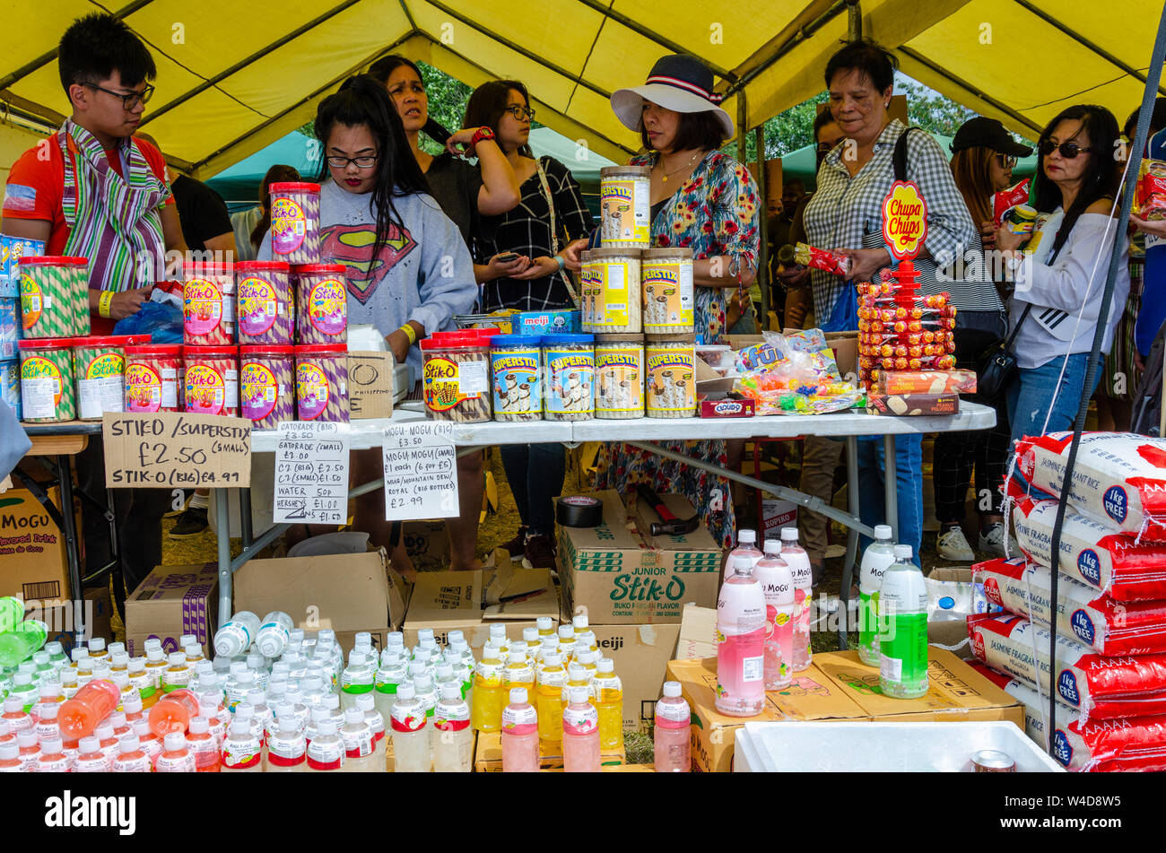 A Filipio food and drink stall at a Filipino cultural event in London sells mogo mogo drinks and stiko biscuits. Stock Photo