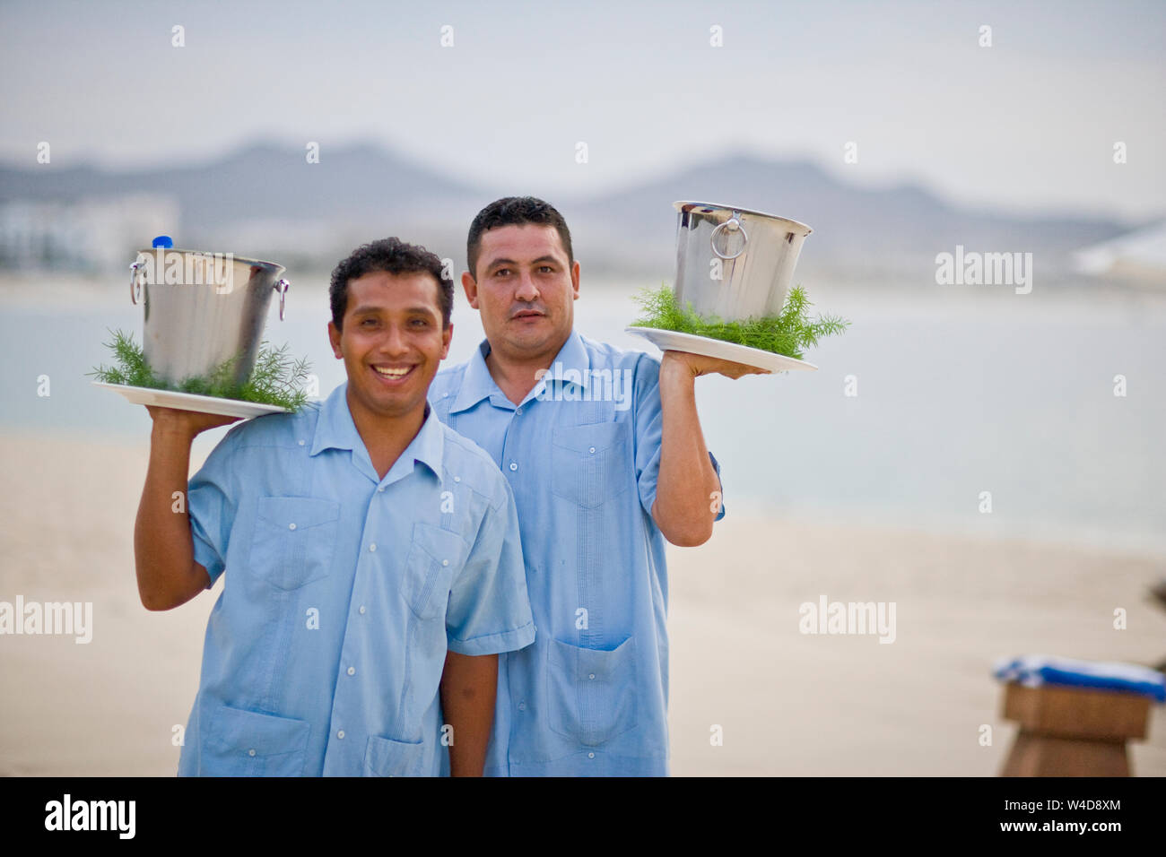 Beach resort waiters holding drinks in ice buckets Stock Photo Alamy