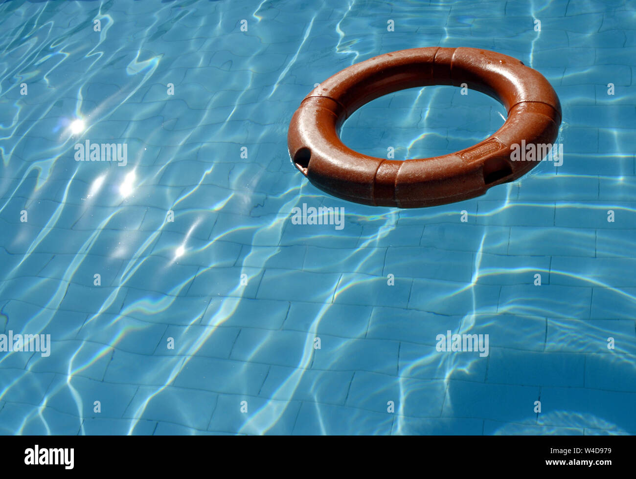 Lifebuoy floating in a swimming pool water Stock Photo