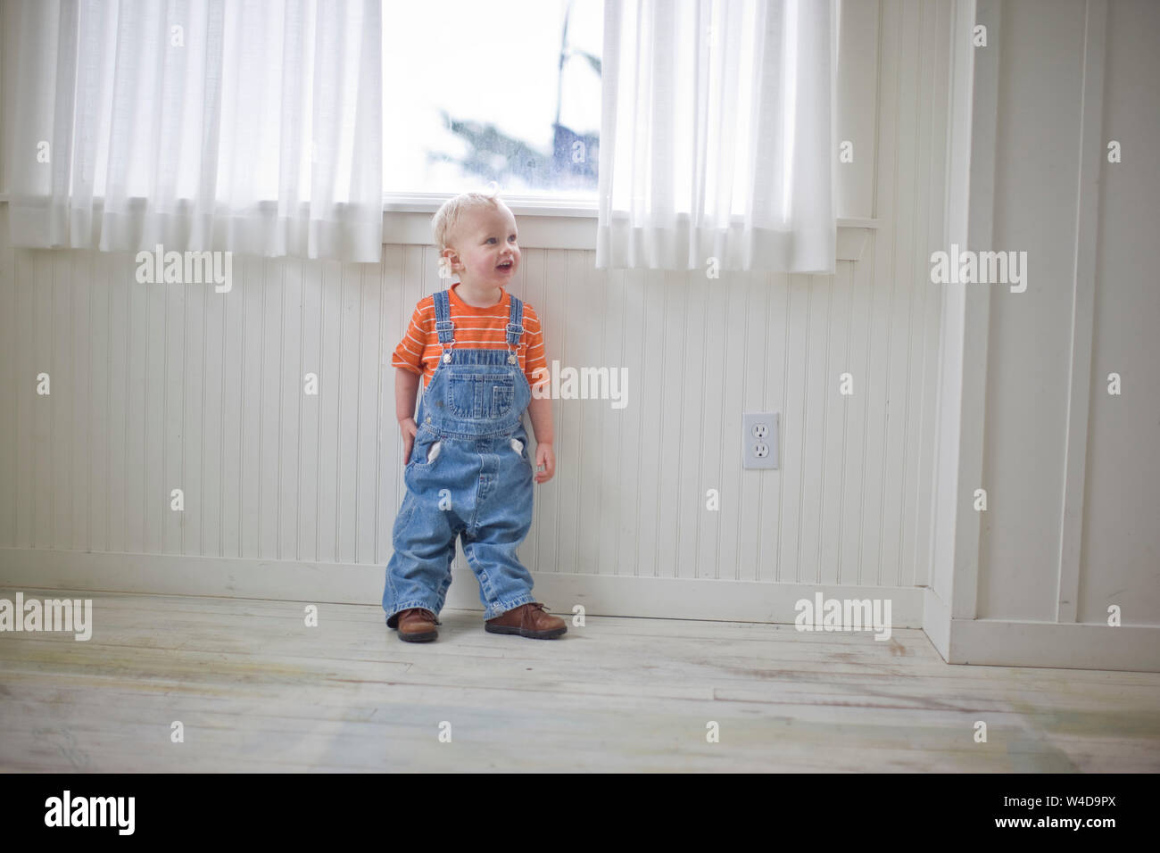 Little boy wearing dungarees Stock Photo Alamy