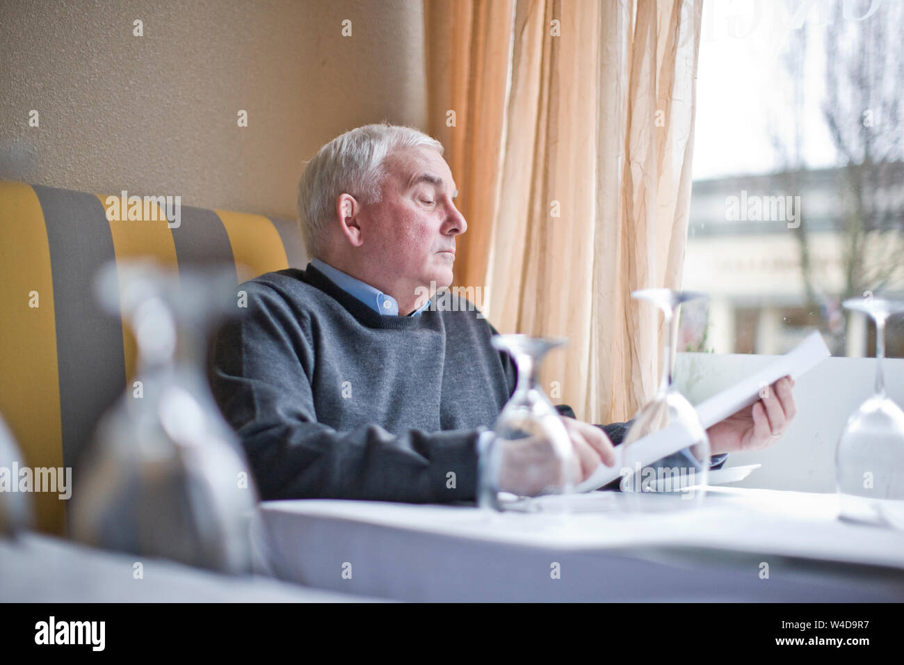 Man looking at menu in restaurant Stock Photo