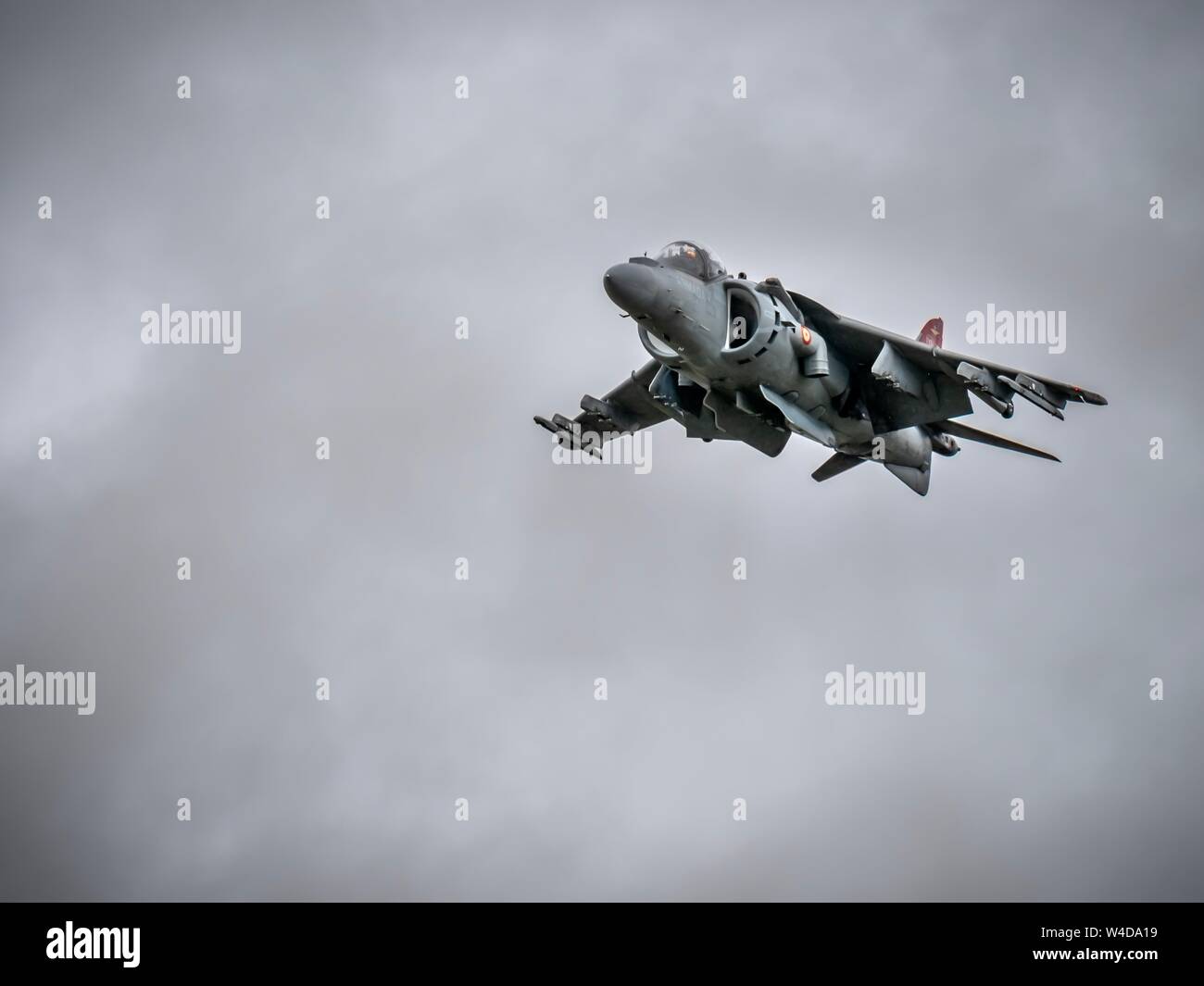 A Spanish Harrier jump jet performing a fly past at the Royal International Air Tattoo at Fairford in the UK on a cloudy day Stock Photo