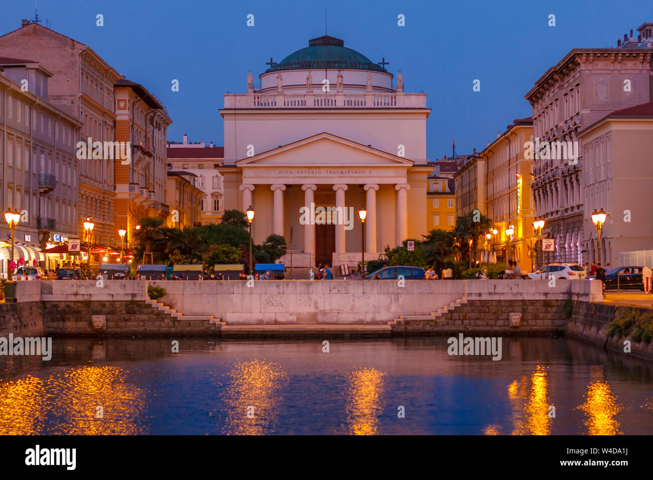 A night view on the Cathedral Chiesa di San Antonio from the bridge of Grade canal in Triest, Italy Stock Photo