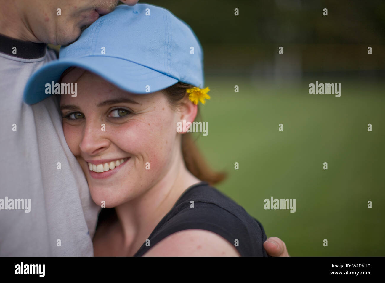 Woman hugging man and smiling at the camera Stock Photo - Alamy