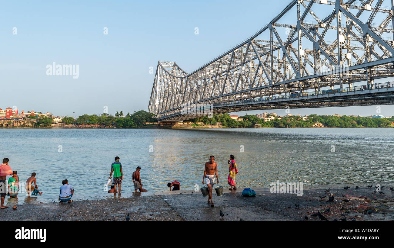 May 27,2018. Kolkata,India. People doing Morning activities on the Bank of Hooghly River overlooking The Howrah Bridge . Stock Photo