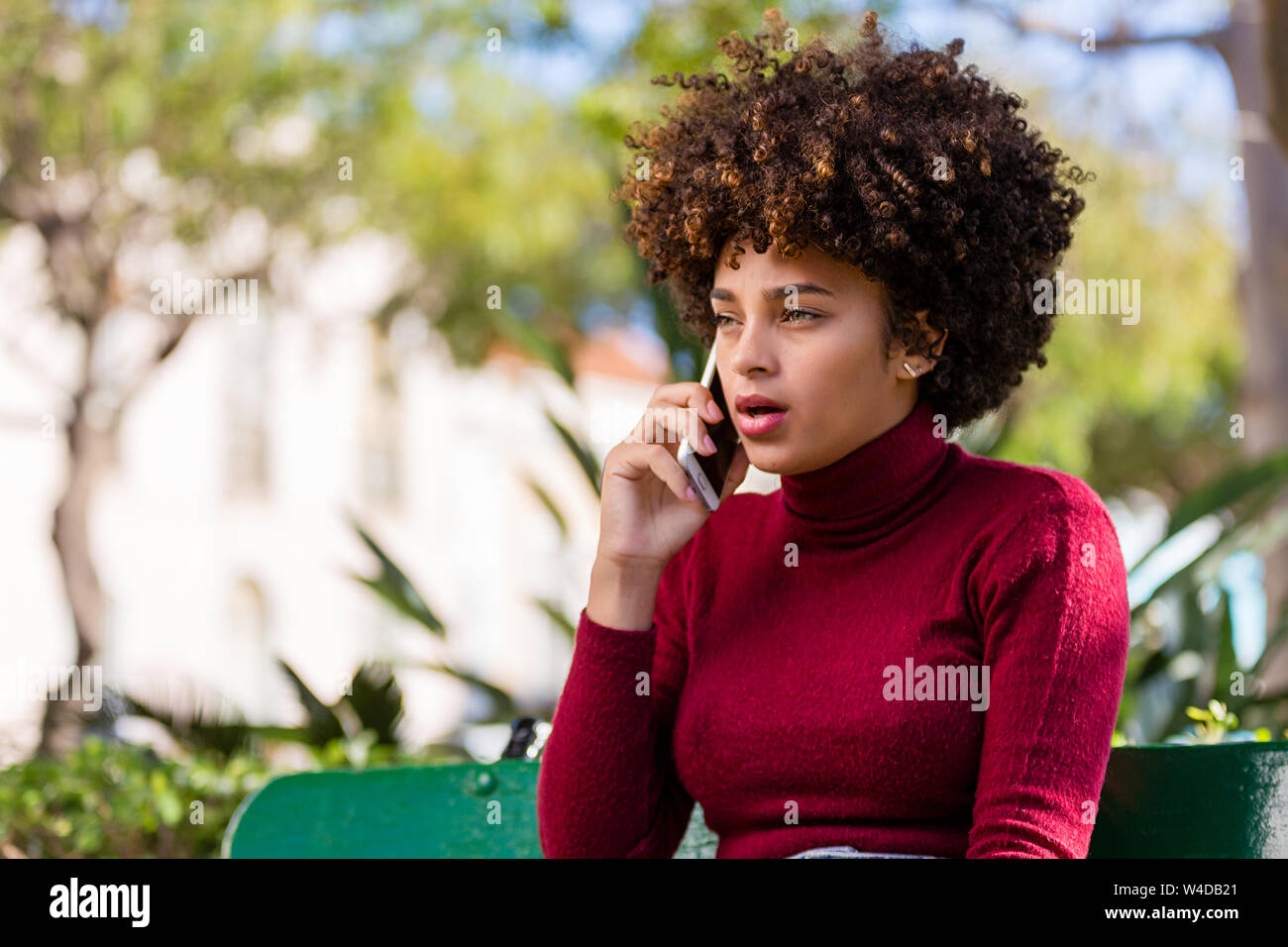Outdoor portrait of a Young black African American young woman speaking ...